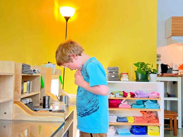 A boy is observing his work as he prepares seeds for planting