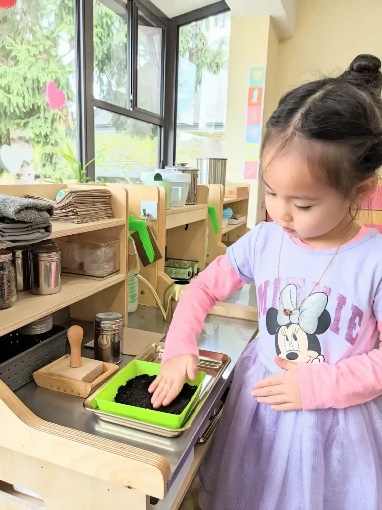 A girl is planting seeds